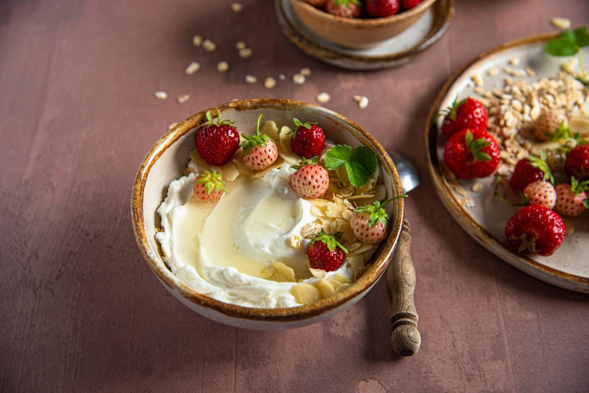 Daily probiotic for gut health capsules next to fresh yogurt and fiber-rich foods